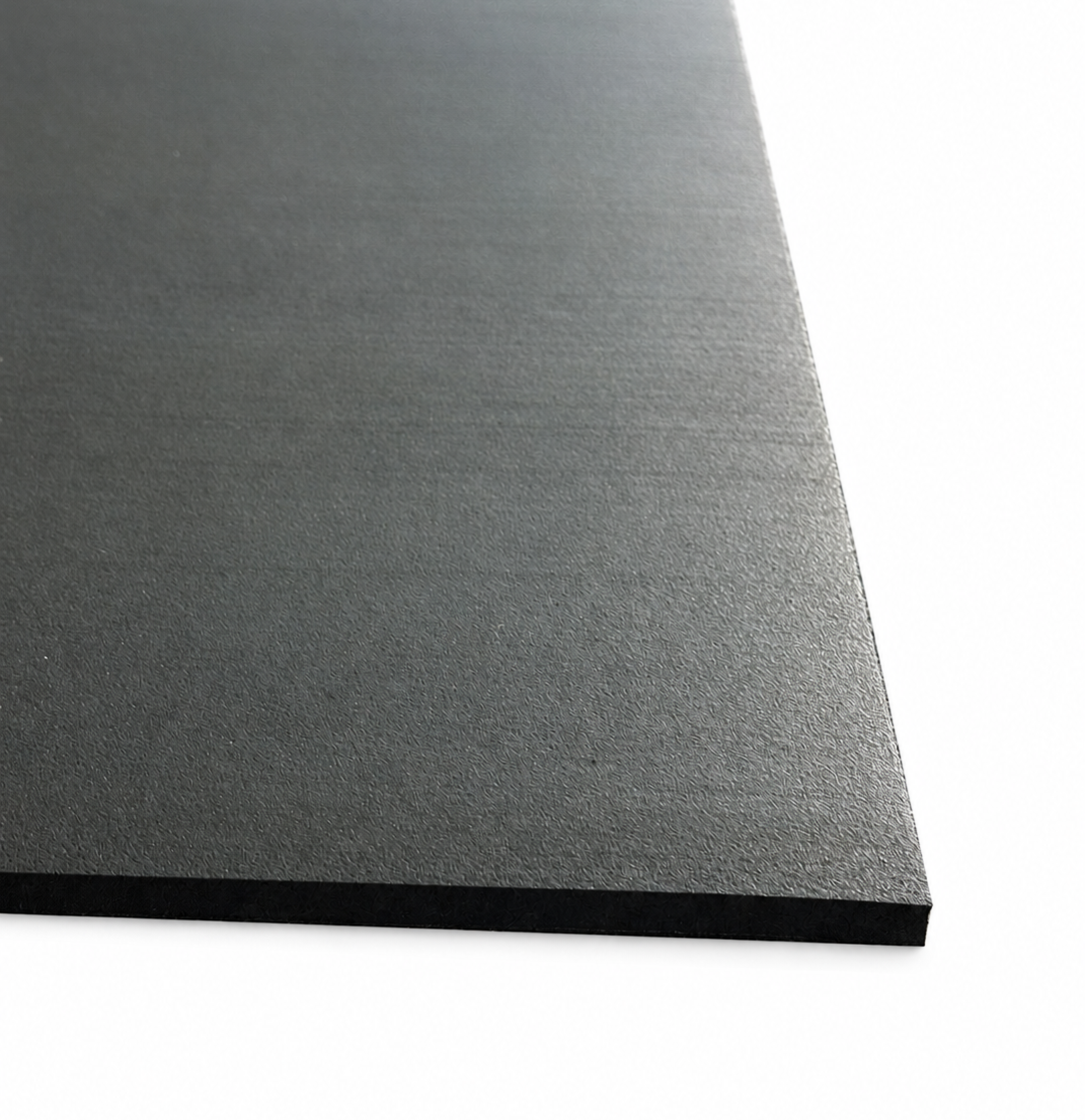 A close-up of a black textured rectangular rubber mat shown at an angle against a white background.